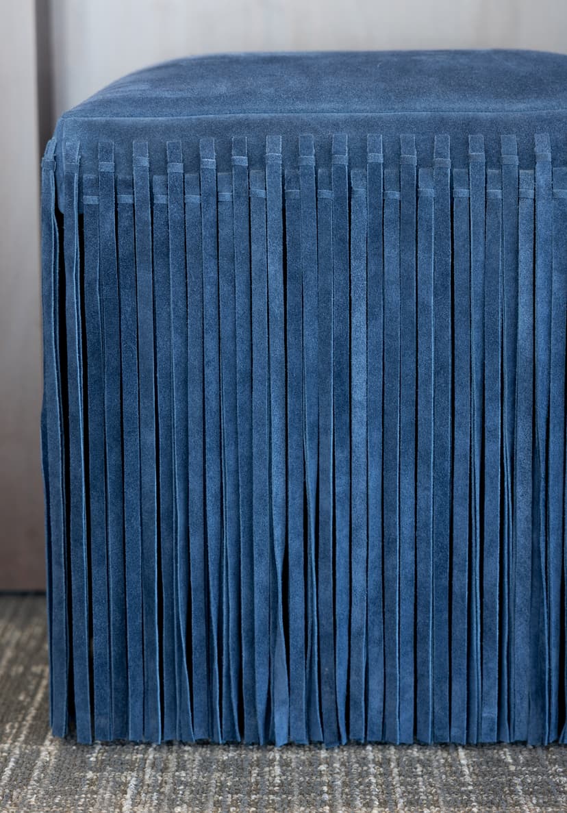 Navy blue fringed suede ottoman inside the Fairfax Title office
